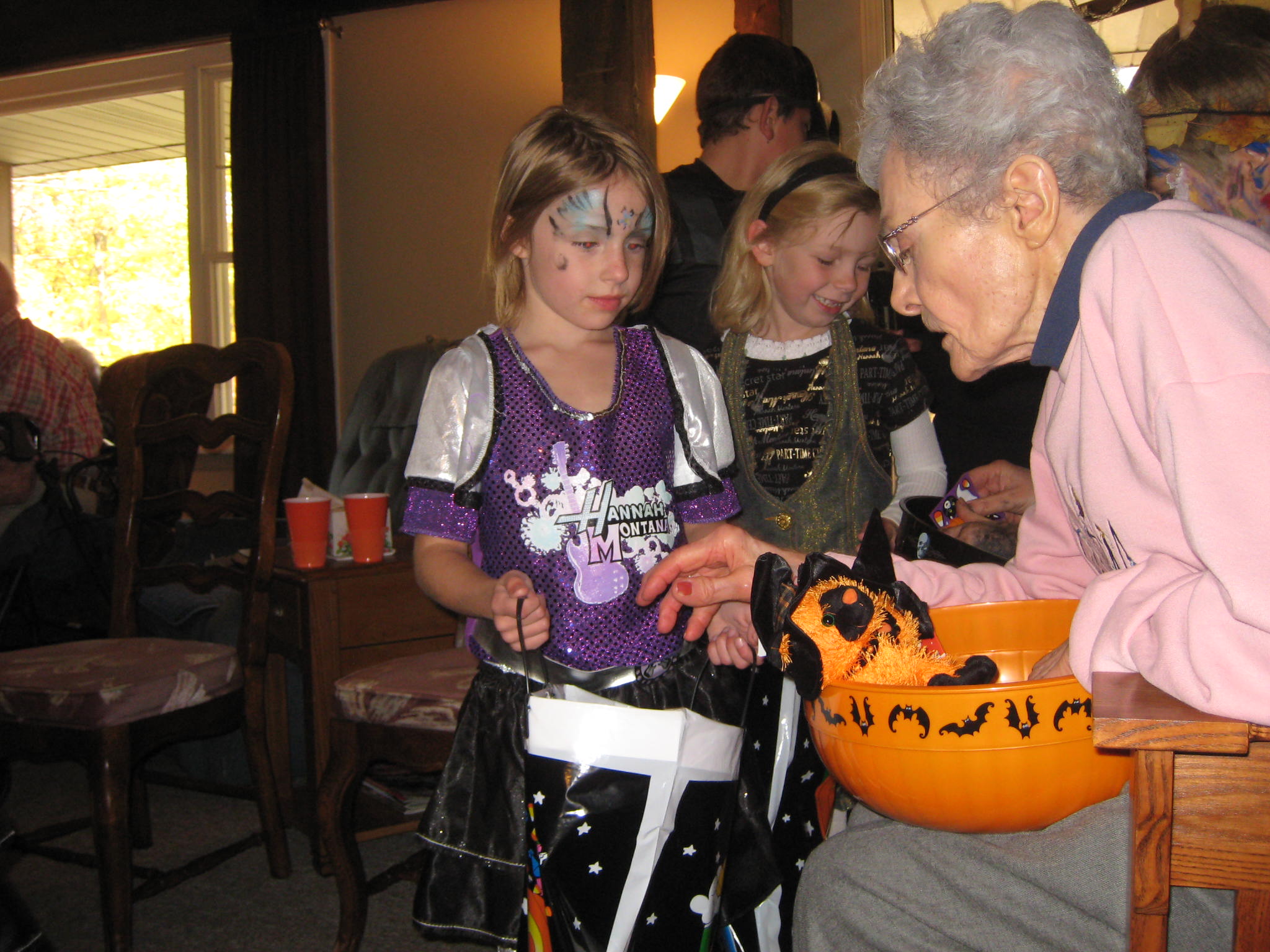 Senior handing out candy to a child