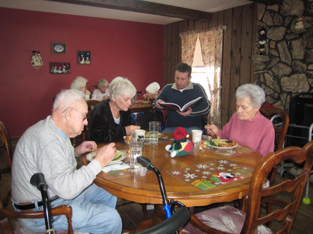 seniors eating and doing activities at a table.